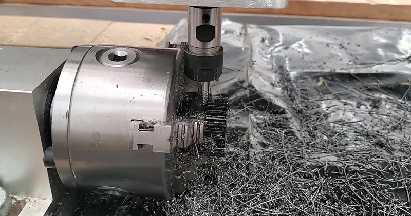 Gear teeth being cut on a part held in a chuck on a rotary axis