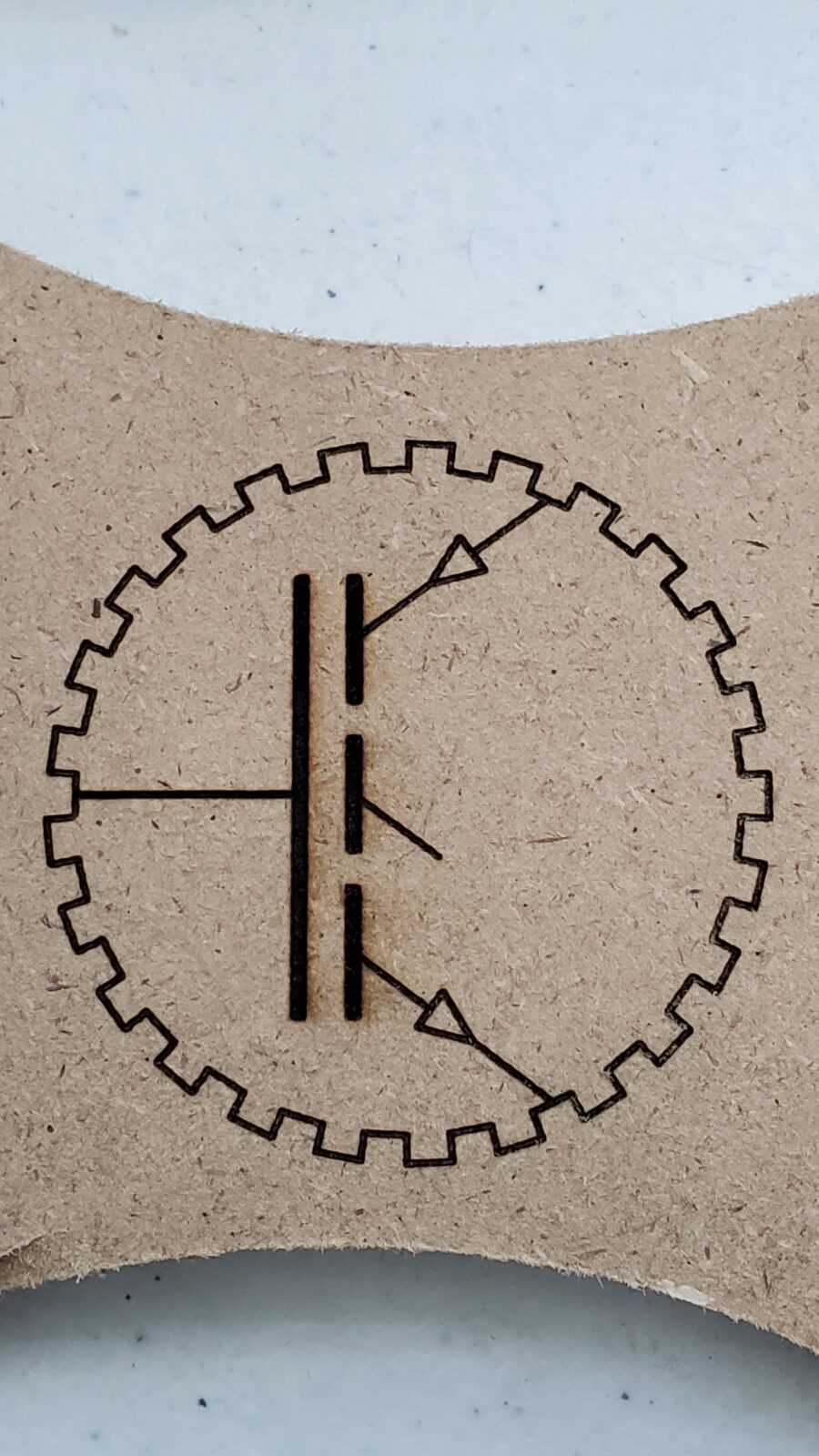 Production Automation Technology gear and transistor emblem laser-engraved on an MDF sample